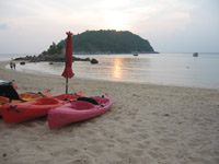 View from Yanui Beach of the sun setting over Koh Kaeo Noi